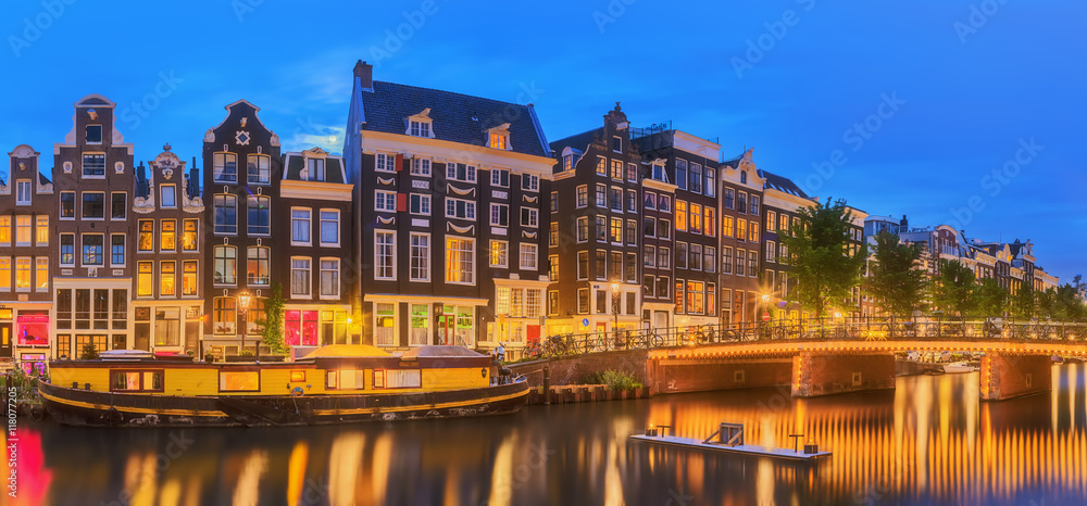 Amstel river, canals and night view of beautiful Amsterdam city. Netherlands