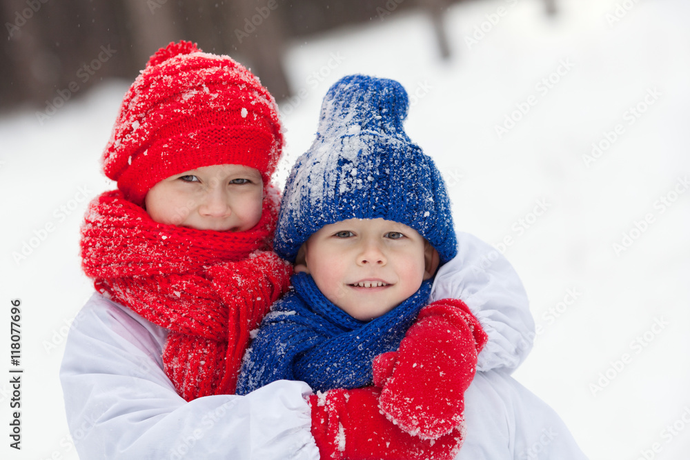Happy brother and sister in costumes snowman walking in winter forest, Happy brother and sister in costumes snowman walking in winter forest,