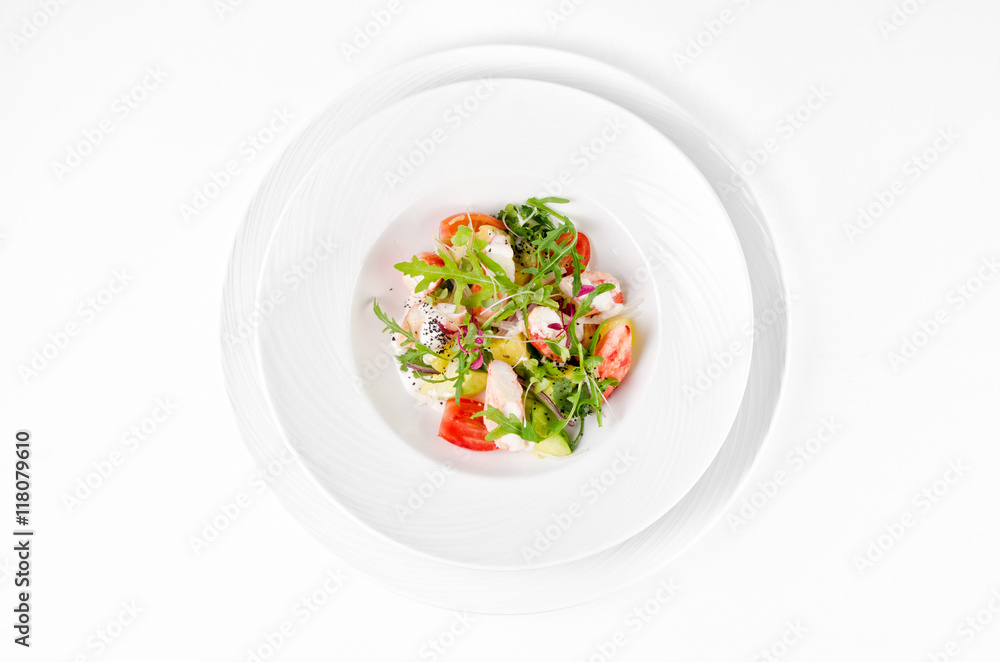 Salad with shrimp, tomatoes, cheese and rocket salad on a plate on a white background, top view Salad with shrimp, tomatoes, cheese and rocket salad on a plate on a white background, top view