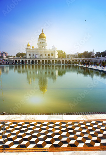 The temple of Sikh religion (1783 year) on the bank of a sacred reservoir, India, Delhi..