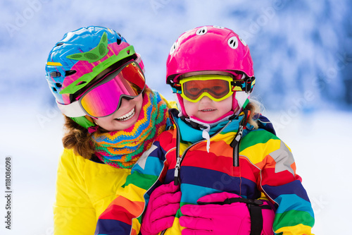 Mother and little girl learning to ski