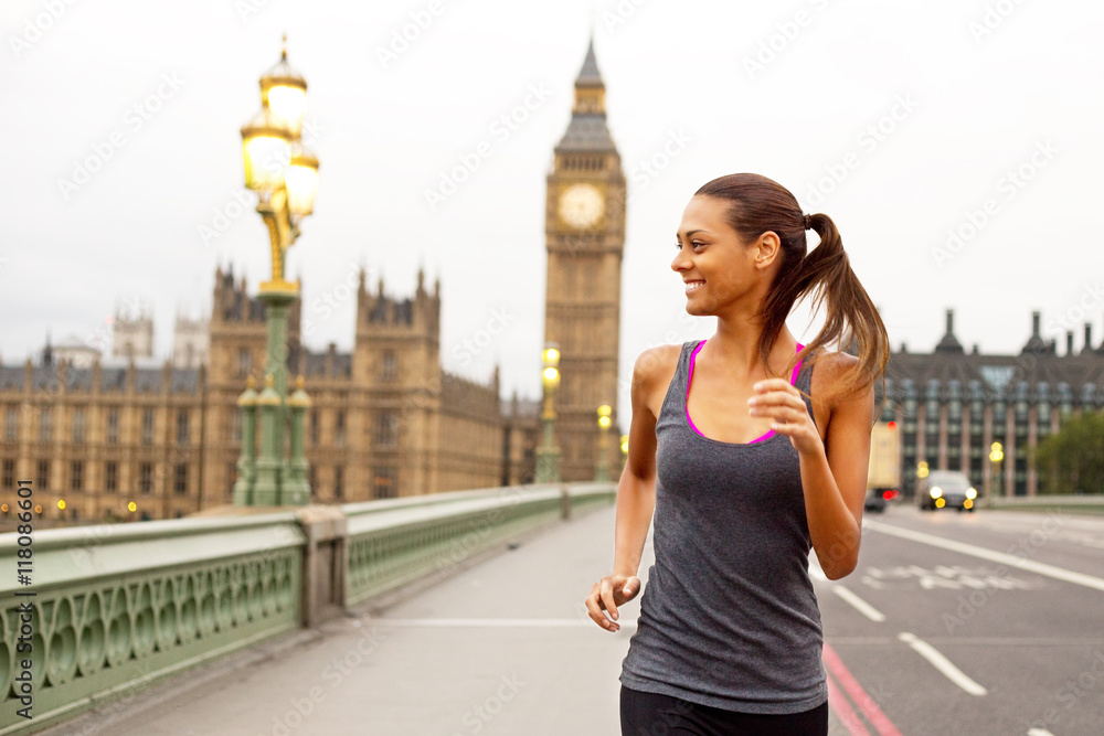 young woman running over westminster bridge in london