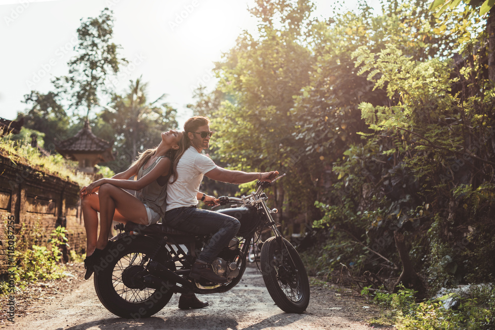 Young couple sitting out on a motorcycle