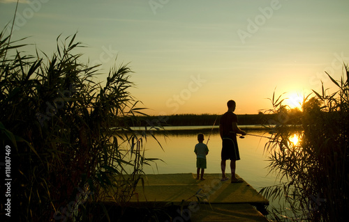 Dad and son fishing on the lake