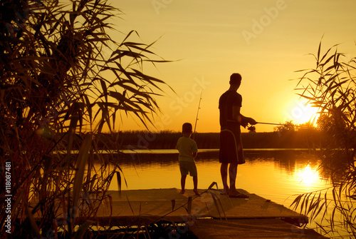 Dad and son fishing on the lake