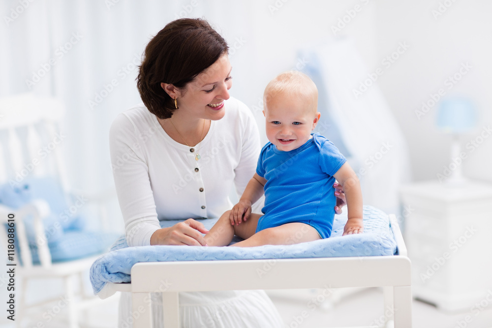 Mother and baby on changing table Mother and baby on changing table