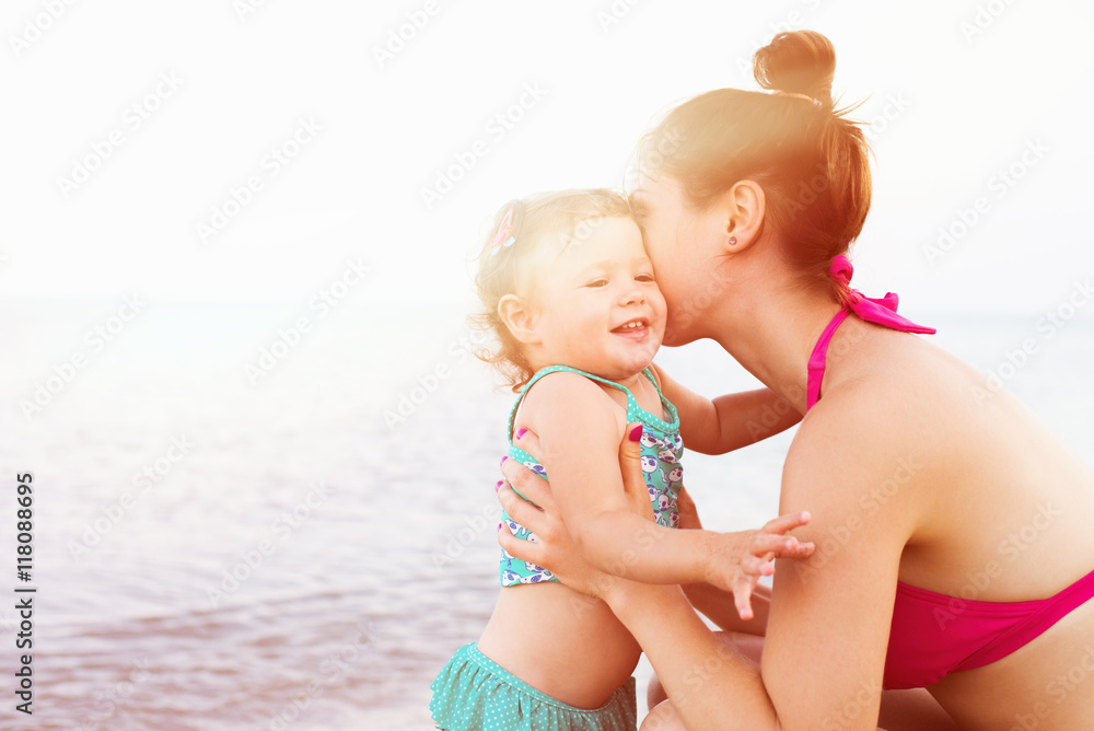 mother and baby having fun on the beach