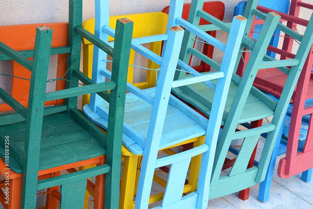 Piled up painted terrace chairs at the beach boulevard
Piled up painted terrace chairs at the beach boulevard