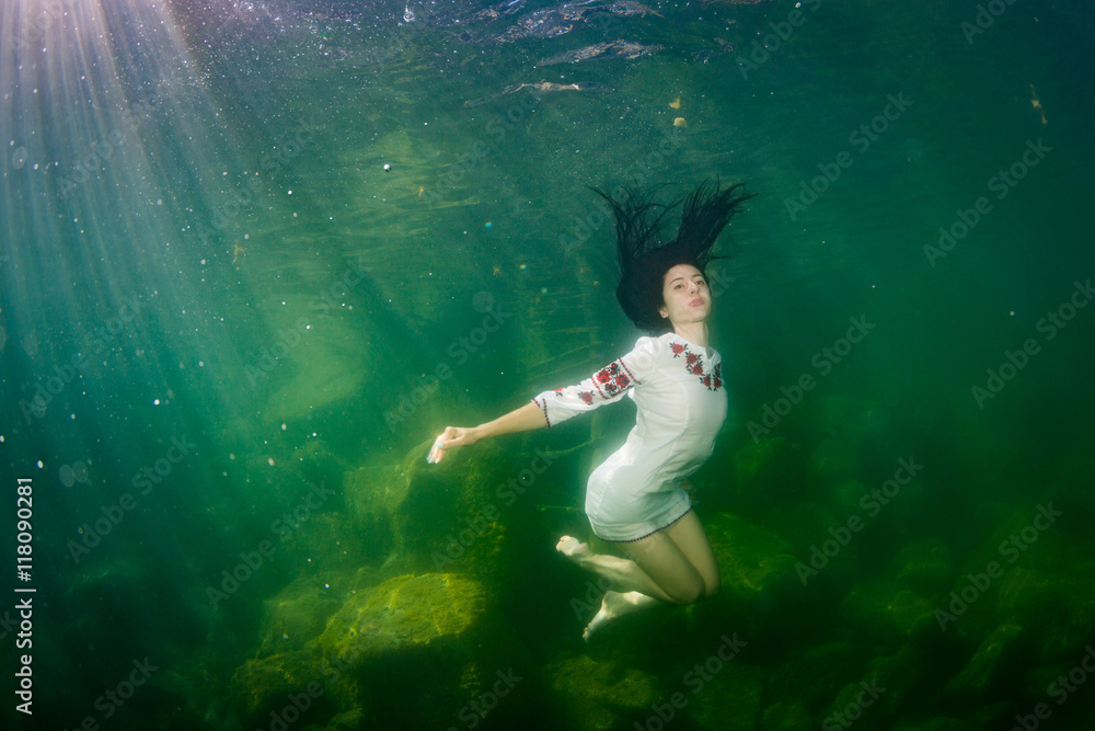 The girl in a embroidery under water