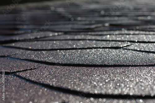 Gleaming shingle roof shortly after rain in sunshine