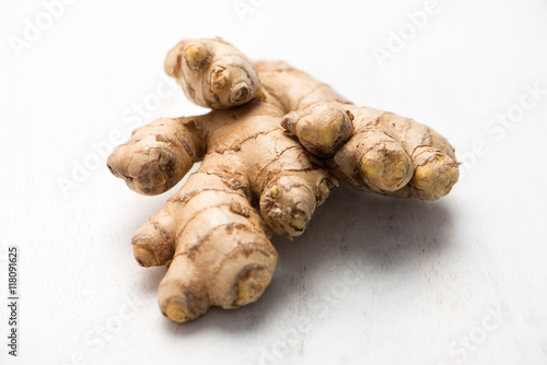 ginger root, isolated on a white cutting board