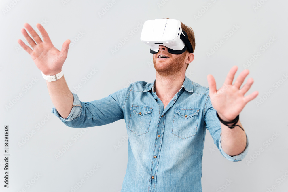 Pleasant cheerful man using virtual reality device Pleasant cheerful man using virtual reality device