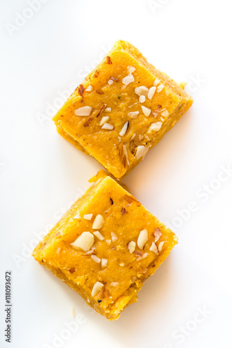Mohanthal is a sweetened gram flour fudges made with Ghee, and flavored with saffron and almonds. It is a traditional Gujarati sweet quite popular during festivals, mainly Diwali