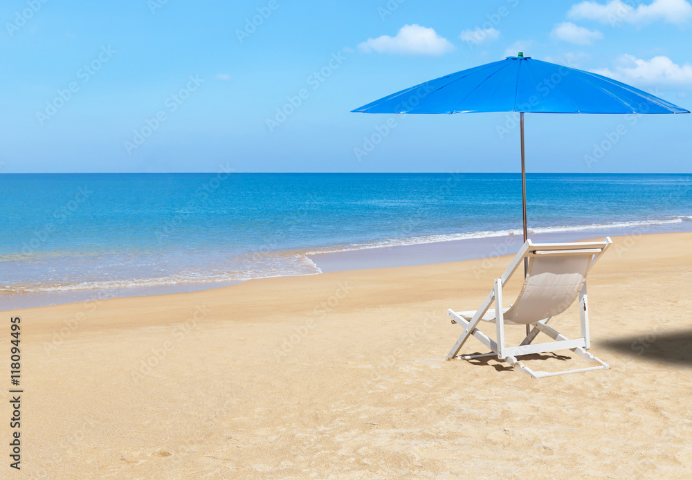 white wooden beach chair and blue parasol on tropical beach in sunny day. white wooden beach chair and blue parasol on tropical beach in sunny day.
