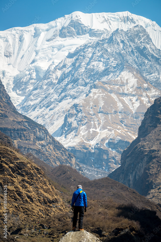 The man standing in front of The Annapurna south face of Himalaya mountains range.
