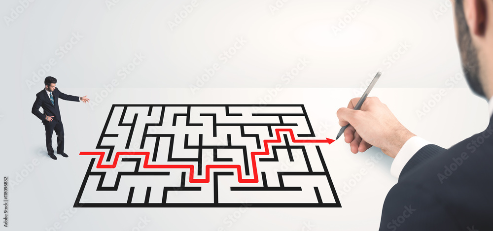 Business man looking at hand drawing solution Business man looking at hand drawing solution
