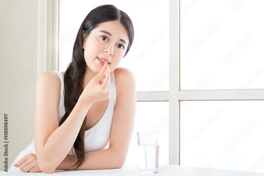 beautiful asian women eating vitamin pill for health care beautiful asian women eating vitamin pill for health care