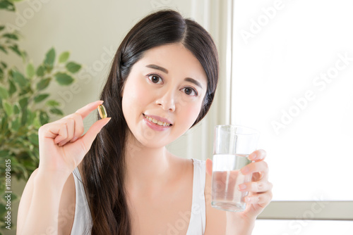 beautiful asian women healthy diet eating vitamin pill