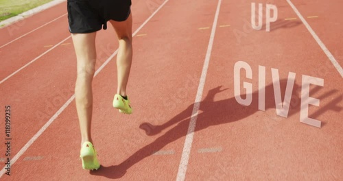 Athletic man running with the sentence inspiration on the floor in outdoor traks photo