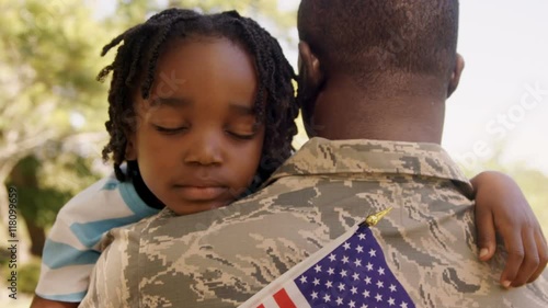 American soldier is hugging his son 