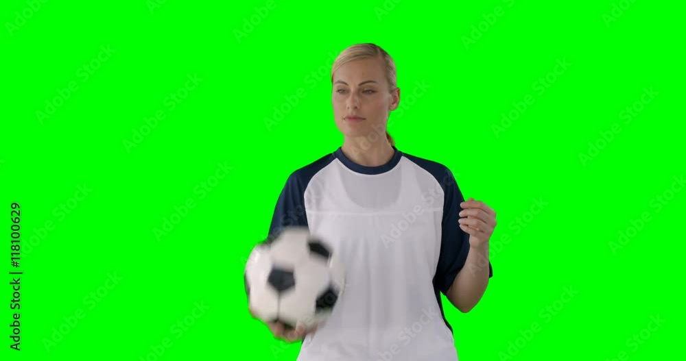 Woman playing with a ball om a green background Woman playing with a ball om a green background