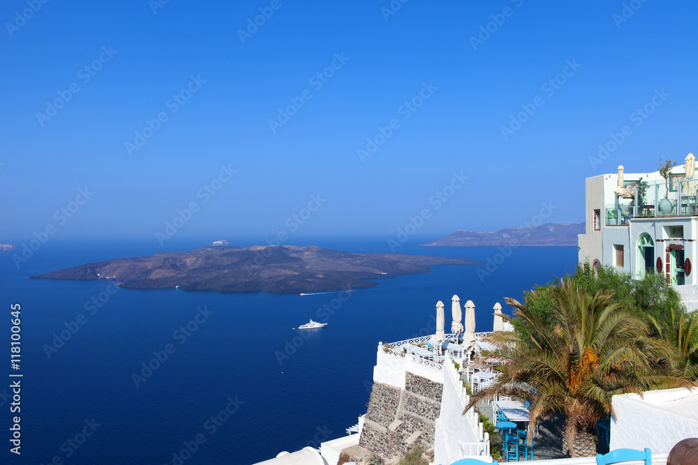 White houses of Fira, Santorini with Santorini's famous volcano in the background