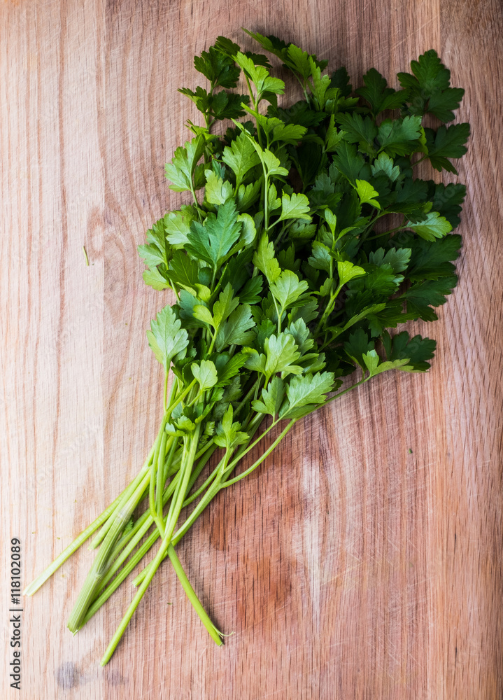 Fresh parsley herbs on wooden chopping board Fresh parsley herbs on wooden chopping board