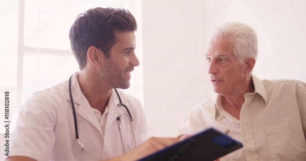 Male doctor and senior man interacting with each other Male doctor and senior man interacting with each other