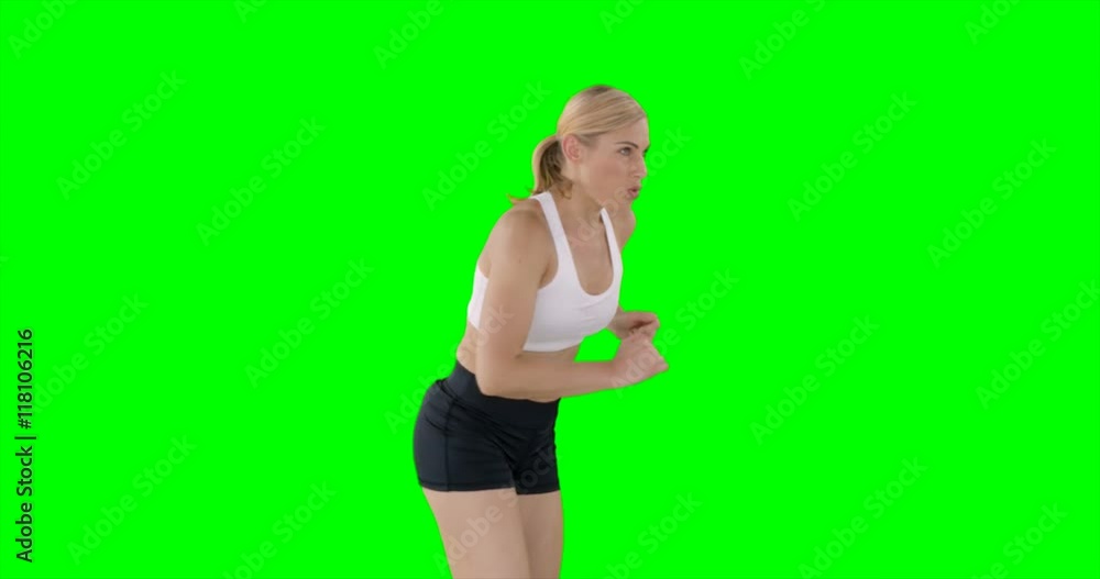 Side view of sportswoman is running against a green screen Side view of sportswoman is running against a green screen