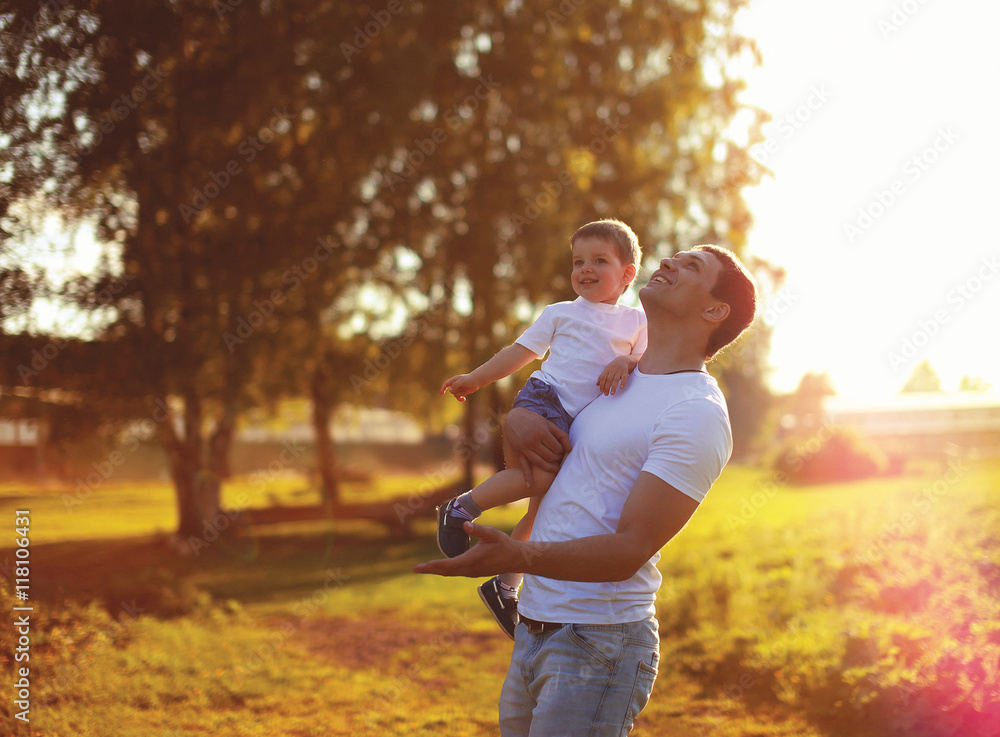 Fototapeta premium Happy father and son child having fun together, enjoying sunny s