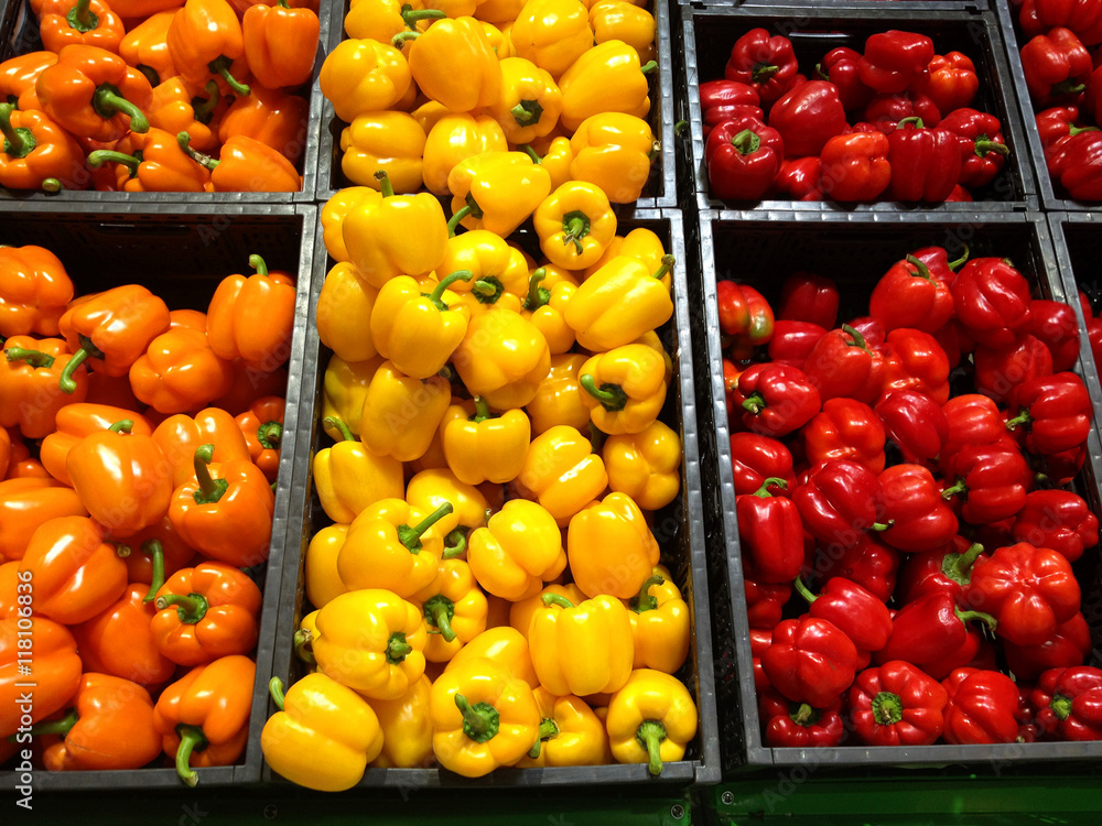 Set of peppers orange yellow and red lying in boxes in supermark Set of peppers orange yellow and red lying in boxes in supermark