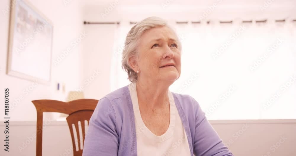 Thoughtful senior woman sitting at home Thoughtful senior woman sitting at home
