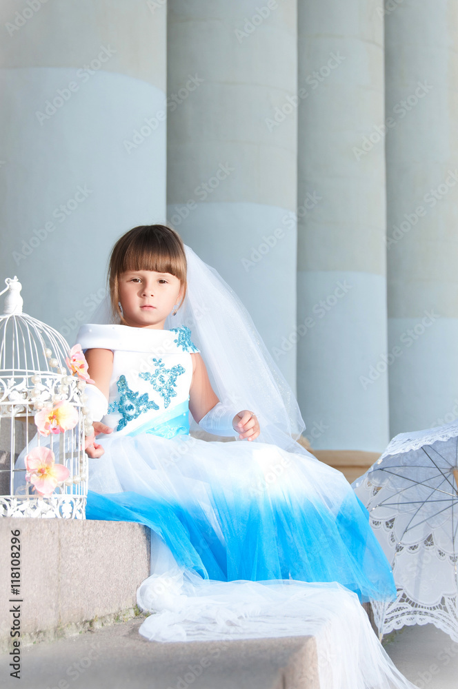 Little fashion-girl in magnificent blue and white evening dress Little fashion-girl in magnificent blue and white evening dress