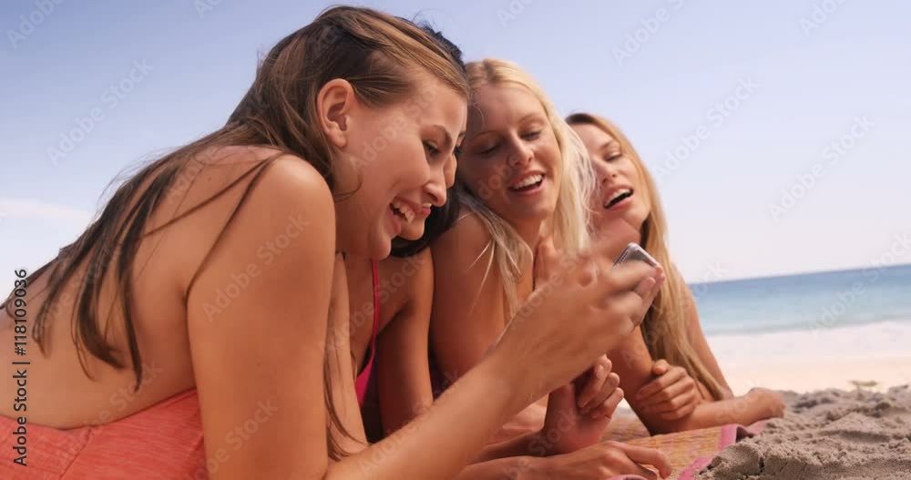 Friends taking a selfie together on a beach Friends taking a selfie together on a beach