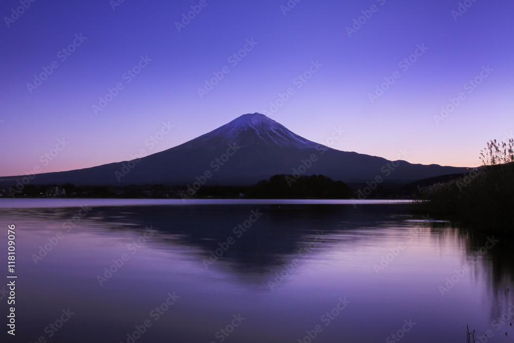 Mount Fuji with a reflection in a lake in Japan early twilight. The white balance is cool tones. Mount Fuji with a reflection in a lake in Japan early twilight. The white balance is cool tones.
