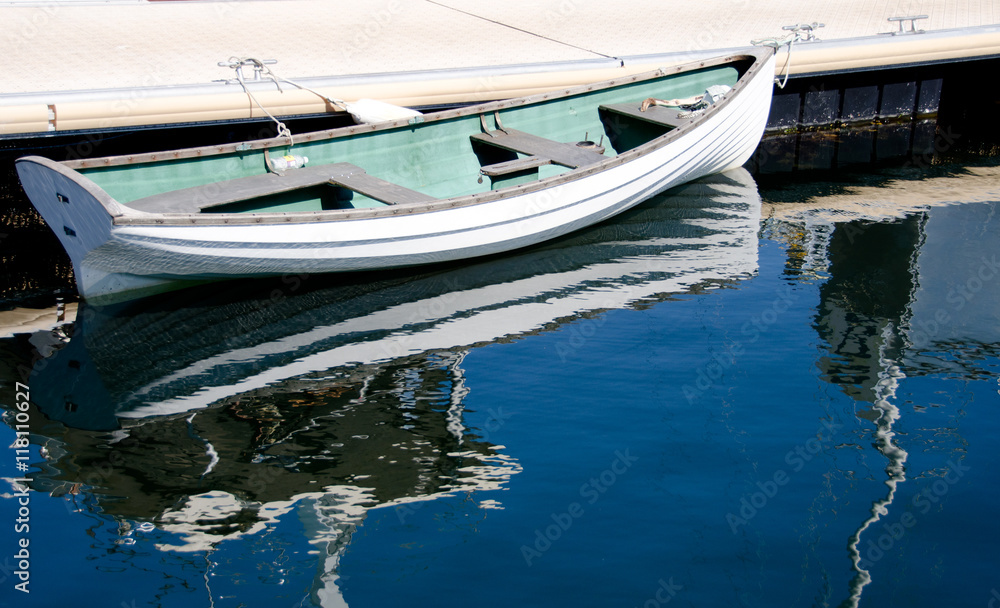 White rowboat parked in Victoria Bay, British Columbia White rowboat parked in Victoria Bay, British Columbia