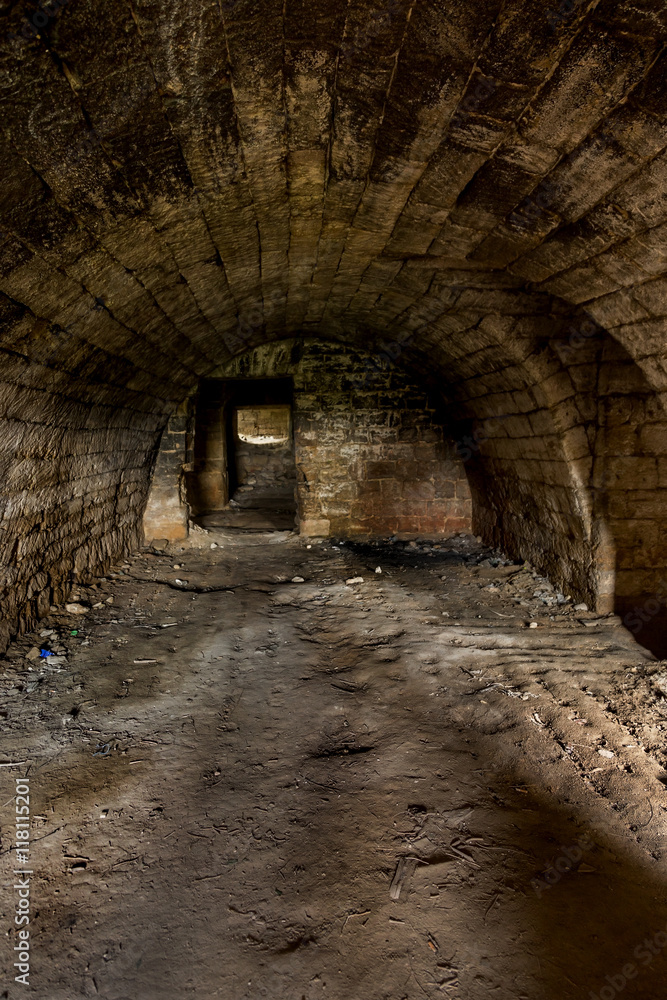Old abandoned tunnel in the underground wine cellar. Entrance to