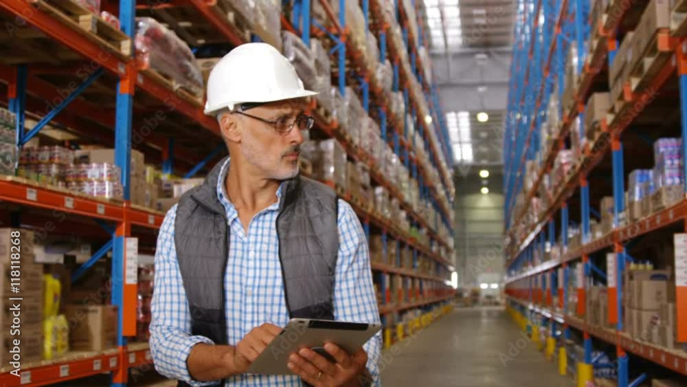 Warehouse worker using his tablet Warehouse worker using his tablet