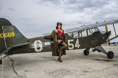 Plane, beautiful redhead pin up style wearing uniform wii with v photo