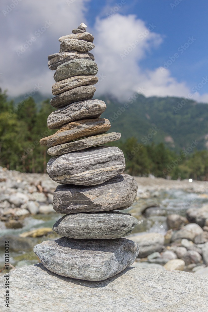 Pyramid from stones on the river bank against a mountain landscape. Pyramid from stones on the river bank against a mountain landscape.