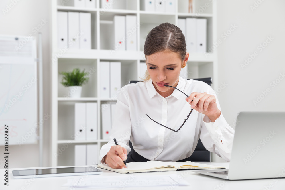 Woman taking notes Woman taking notes