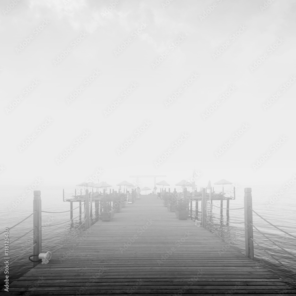 wooden pier in sea mist