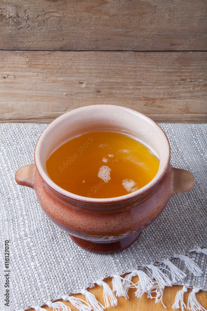 Clay pot with ghee and spoon on linen napkin. Rustic still life. Clay pot with ghee and spoon on linen napkin. Rustic still life.