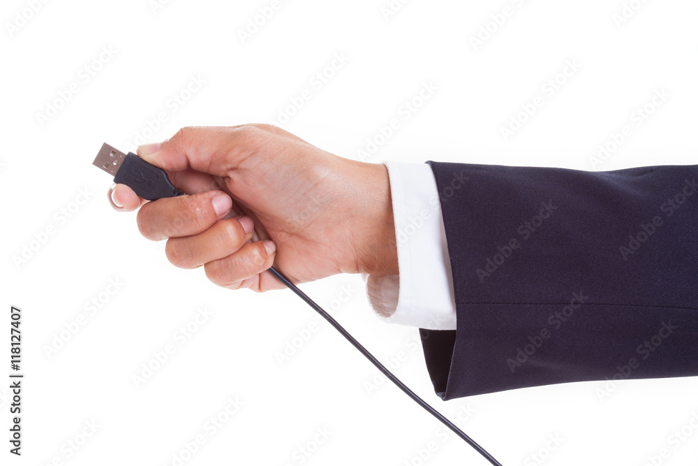 Hand holding USB cable Hand holding USB cable