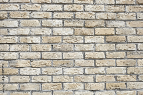 Wall from beige bricks front view closeup horizontal photo