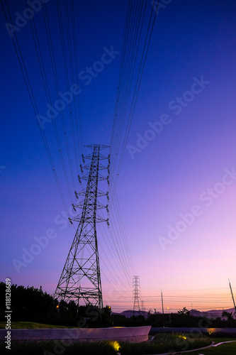 High voltage pole against twilight sky