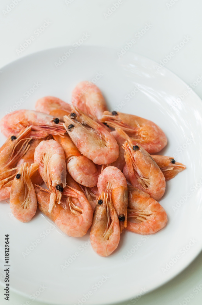 Shrimp on a white plate. Composition on white background Shrimp on a white plate. Composition on white background