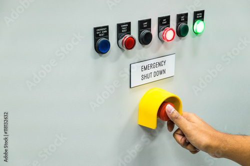 Technician is turning on emergency shutdown button on control pa
