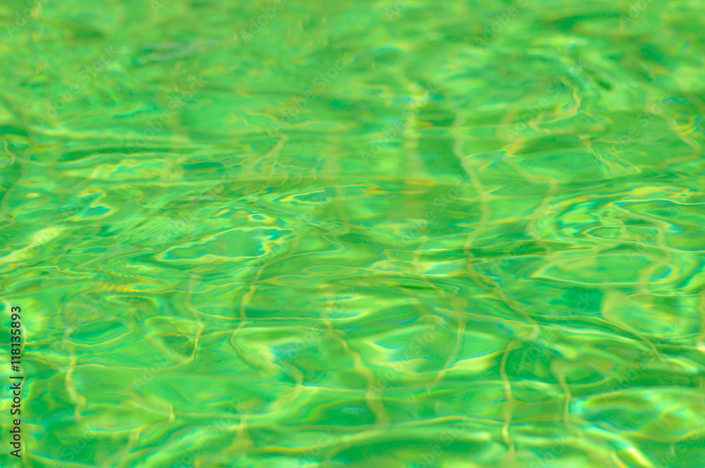 Emerald green water surface with sun reflection in swimming pool Stock