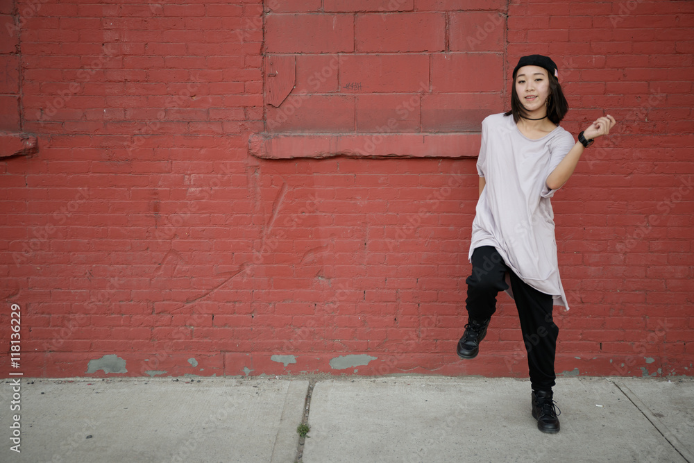 Young Asian woman in city dancing hip hop Young Asian woman in city dancing hip hop